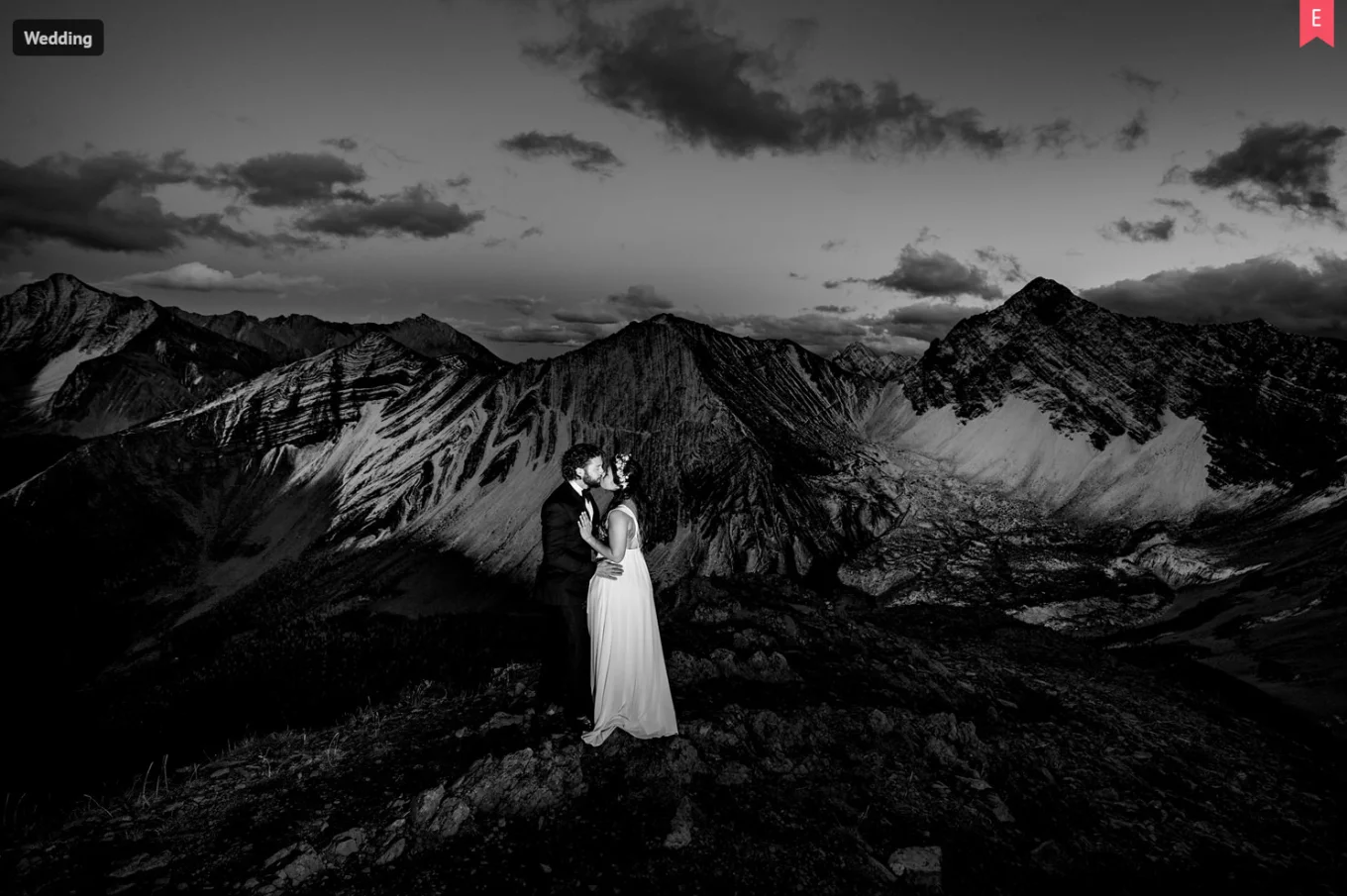 Newlyweds on the top on the mountain in Banff.