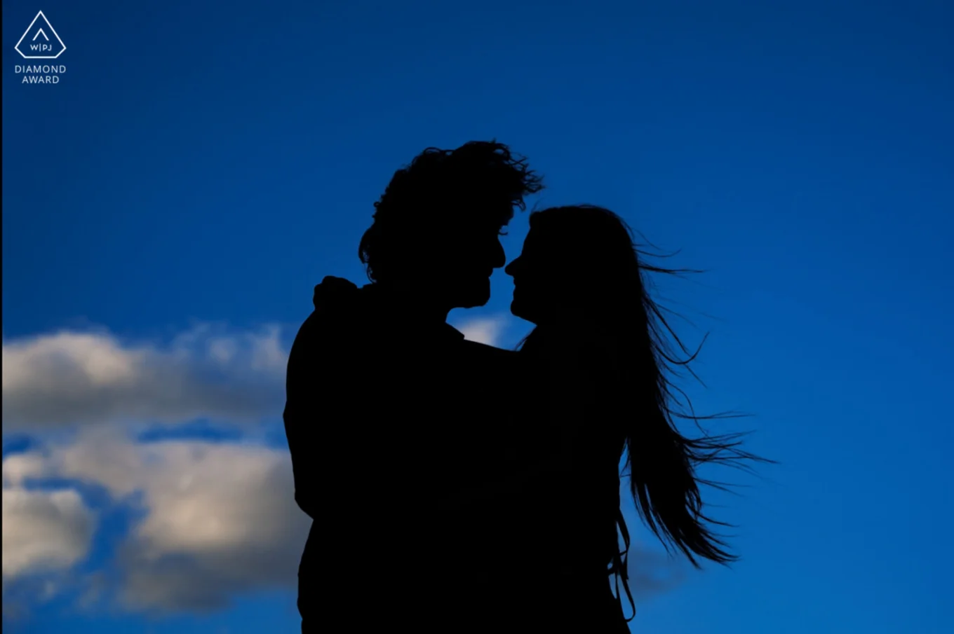 Silhouette couple hugging each other.