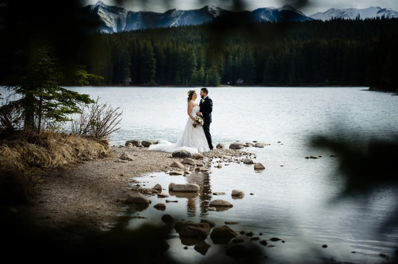 Shoot through the tree on the newlyweds. Creative wedding photography