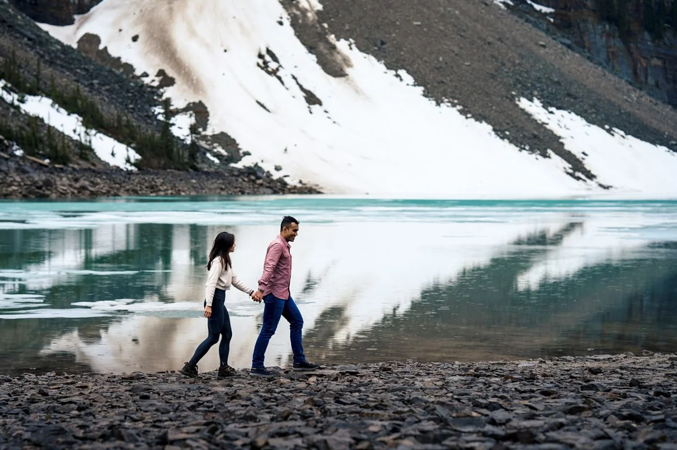 Engaged couple walk down the Moraine Lake.