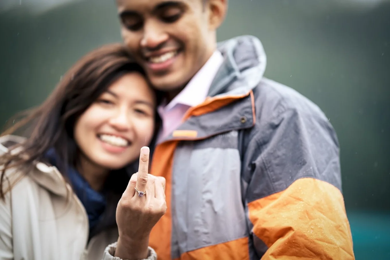 smiling couple in love. A girl shows her ginger with a brand new engagement ring