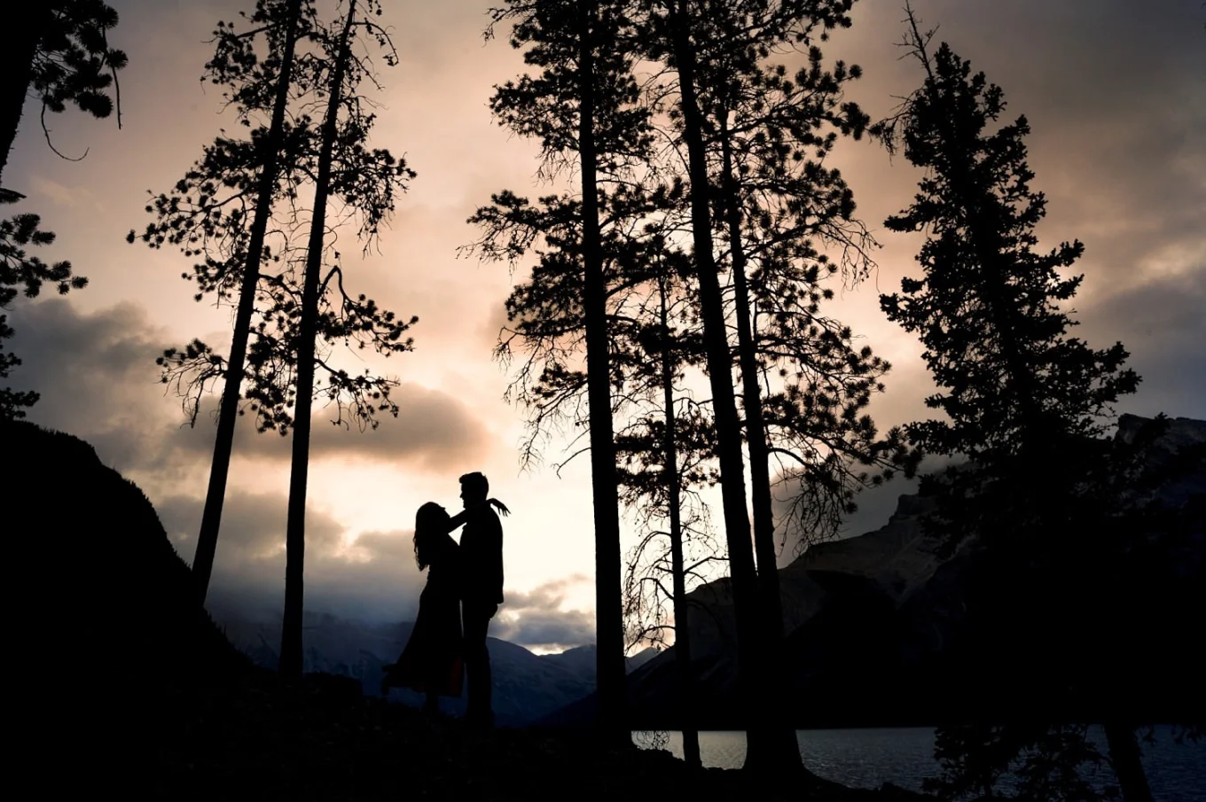silhouette photo of engaged couple at Minnewanka Lake in Banff