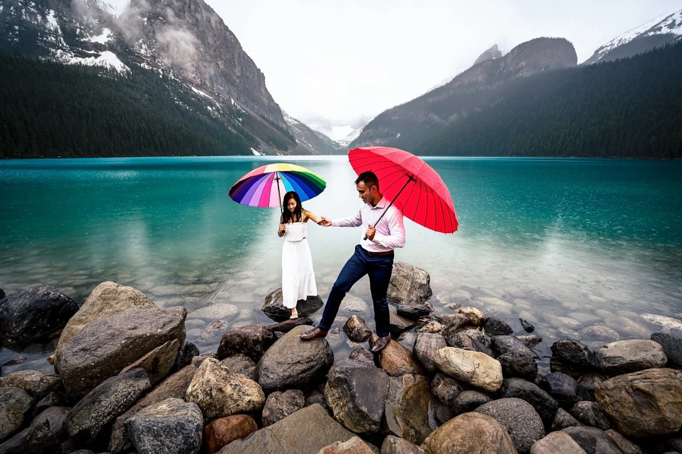 Couple walking down the Lake Louise on the rainy day.