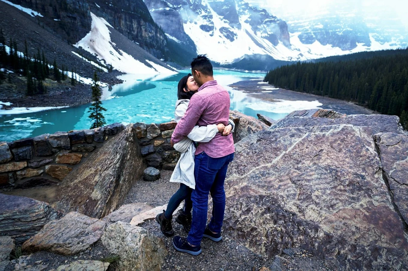 a couple share a kiss after proposal.