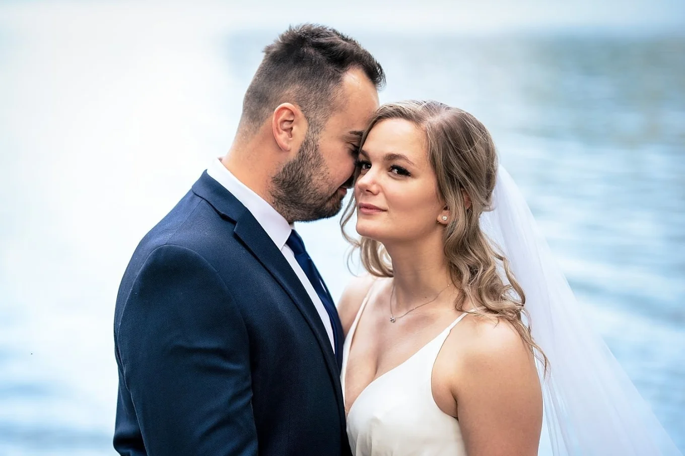 Groom touches the bride head with his nose. Romantic scene
