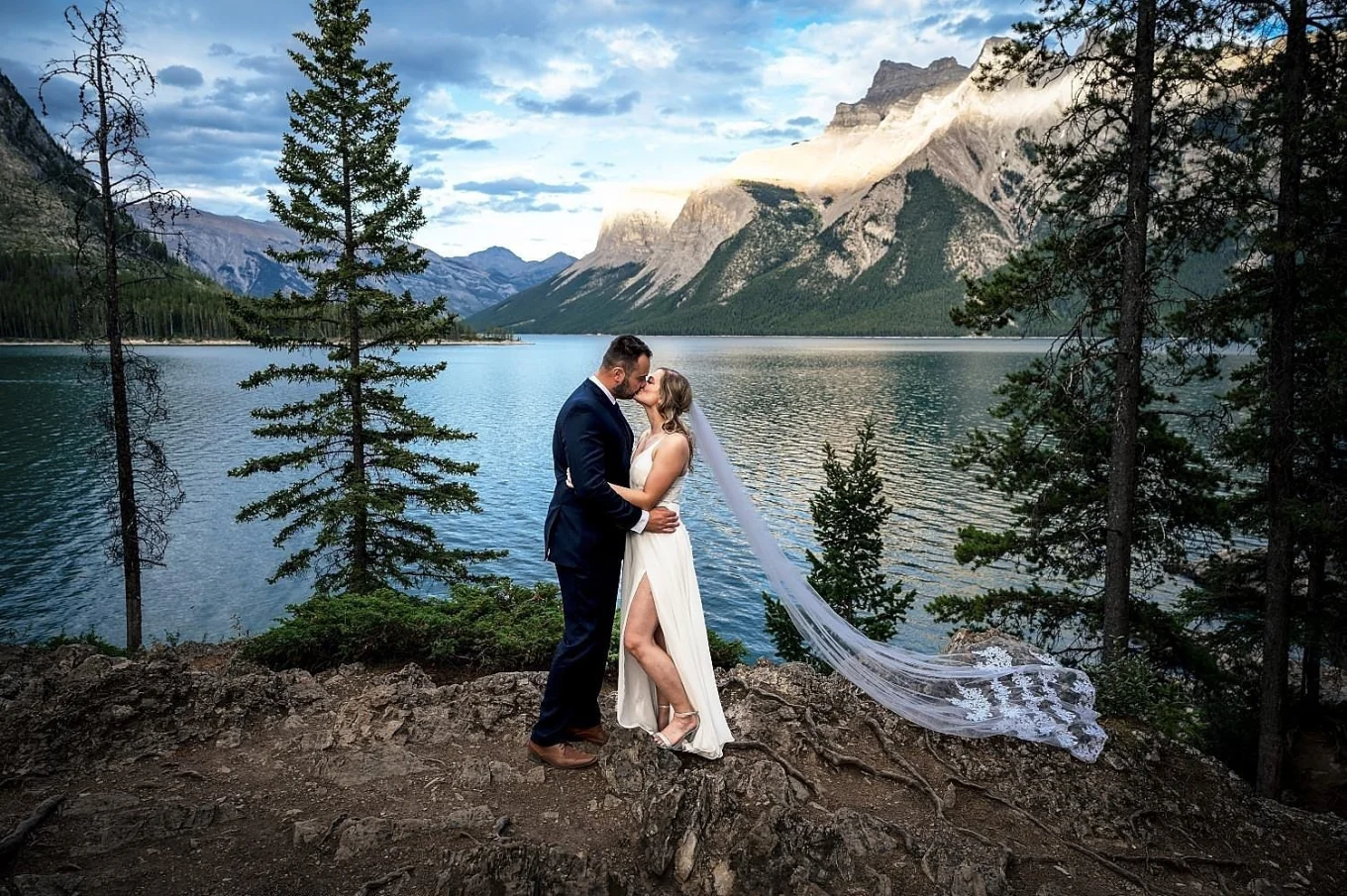 bride and groom hug each other against the stunning view of the lake in Banff