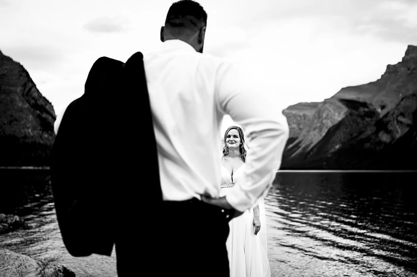 Photography through the grooms arm on beautiful bride