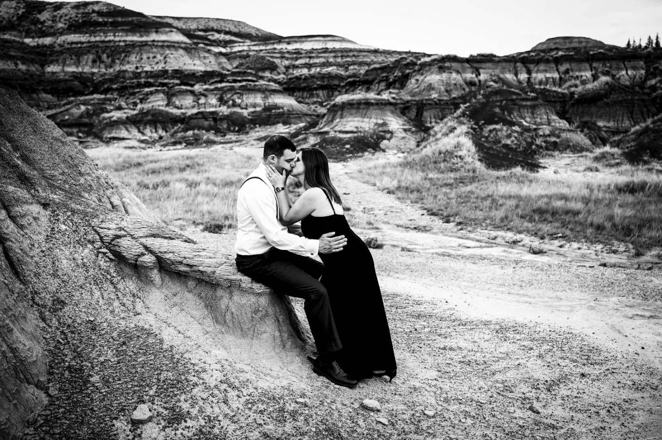 After-wedding photograph of kissing couple in black and white.