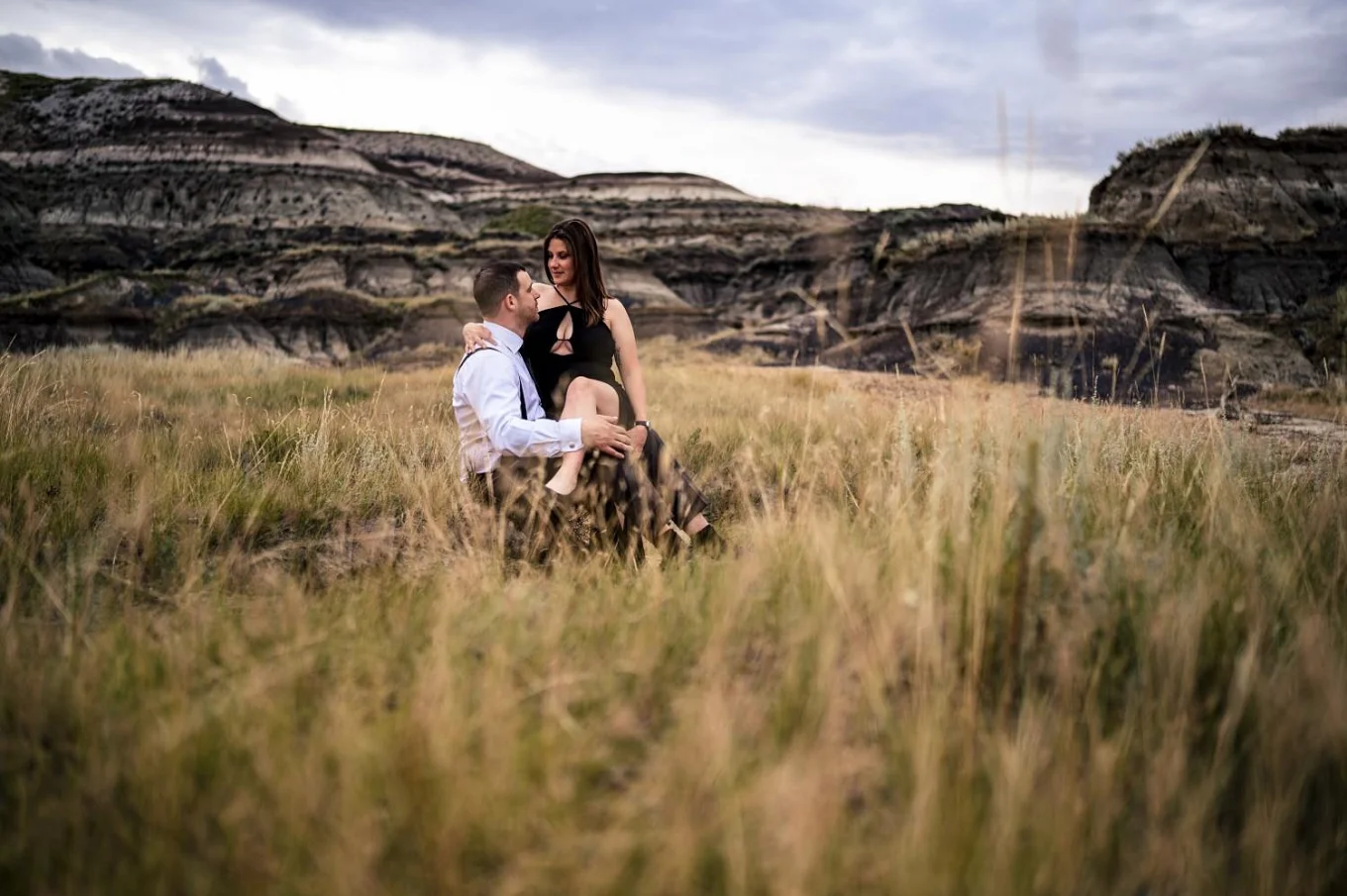 lady sits on her husbands lab during their after-wedding session with the best Calgary Wedding Photographer.
