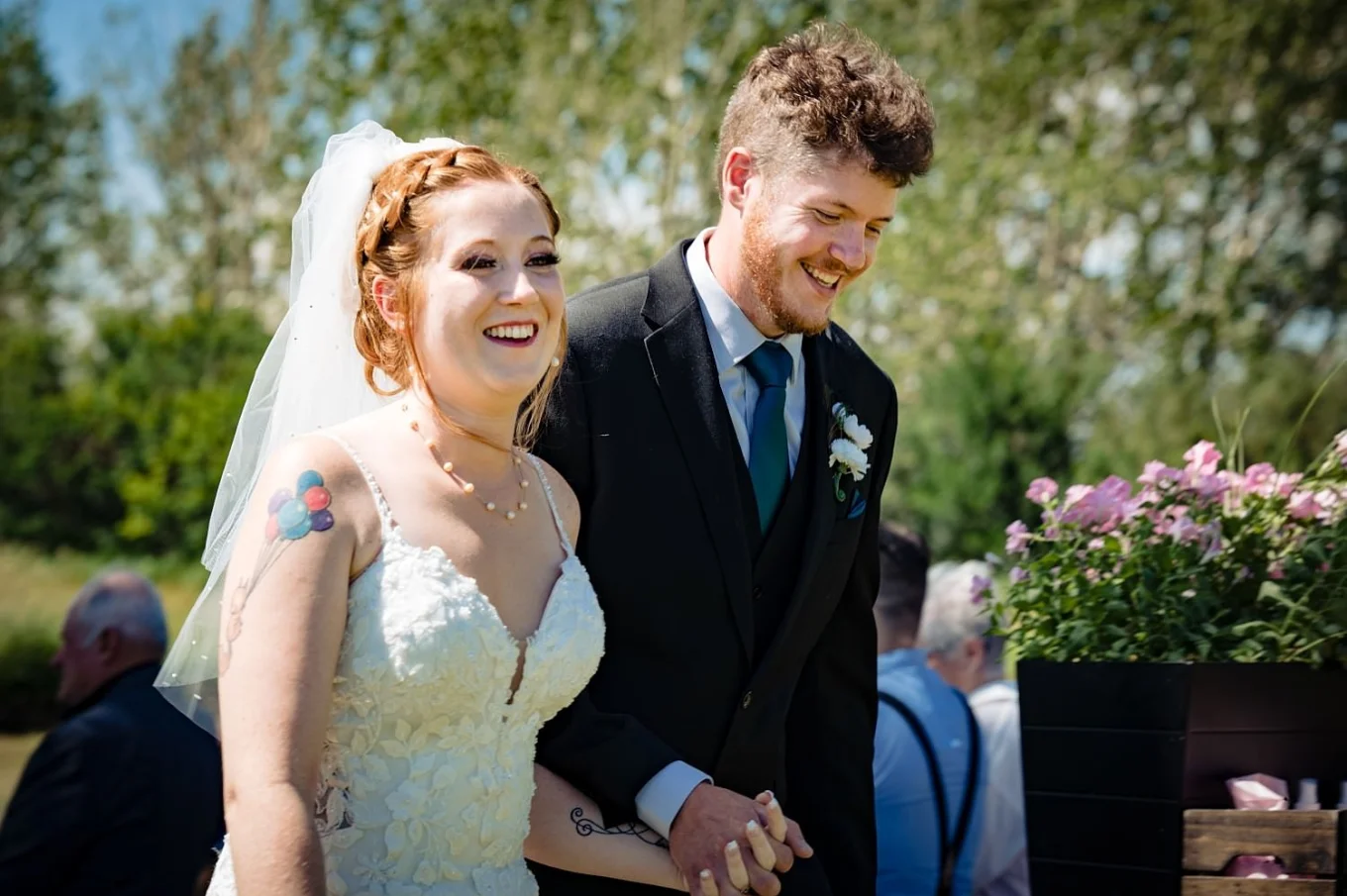 Bride and groom hold their hands white