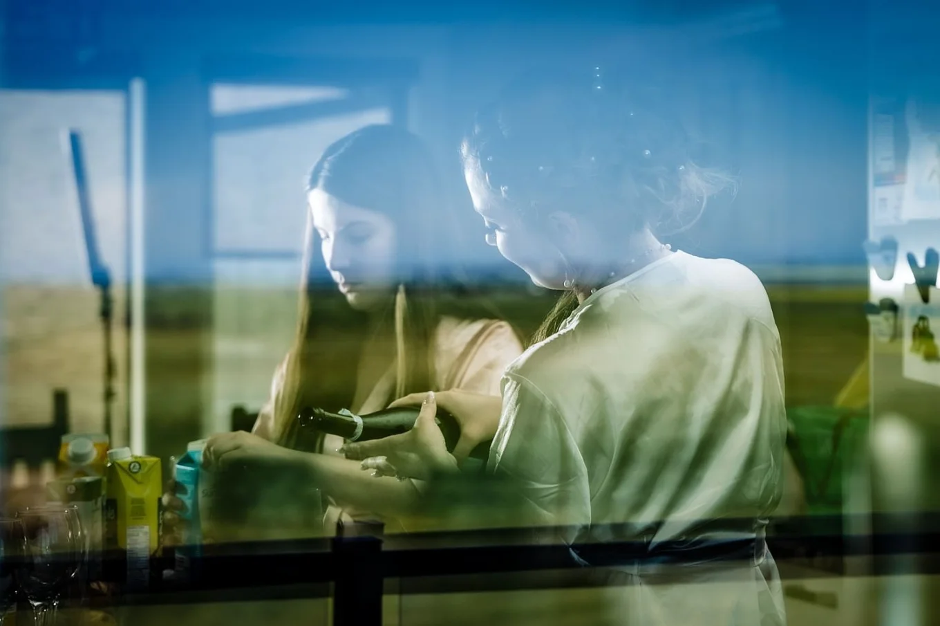 Photograph of bride and bridesmaid through the winnow.