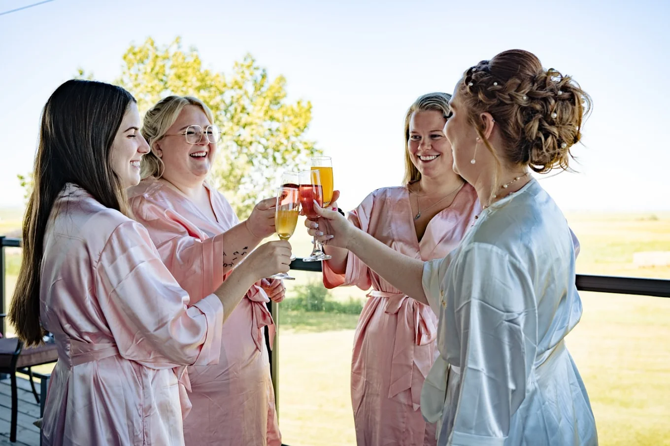 Bridal party clink the glasses during getting ready time at countryside wedding in Calgary.
