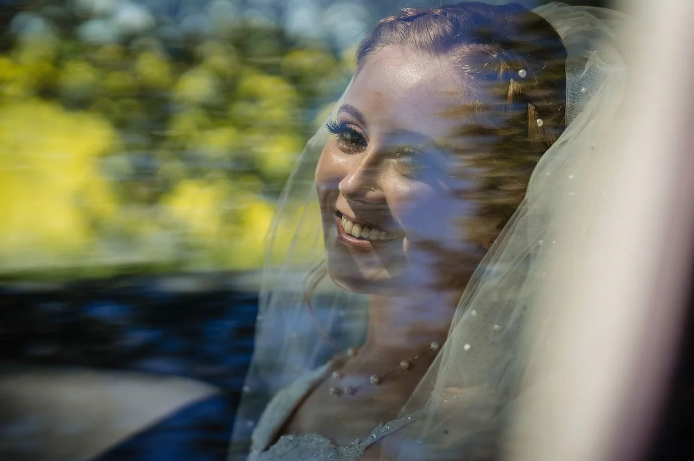 Bride's portrait through the car's window.
