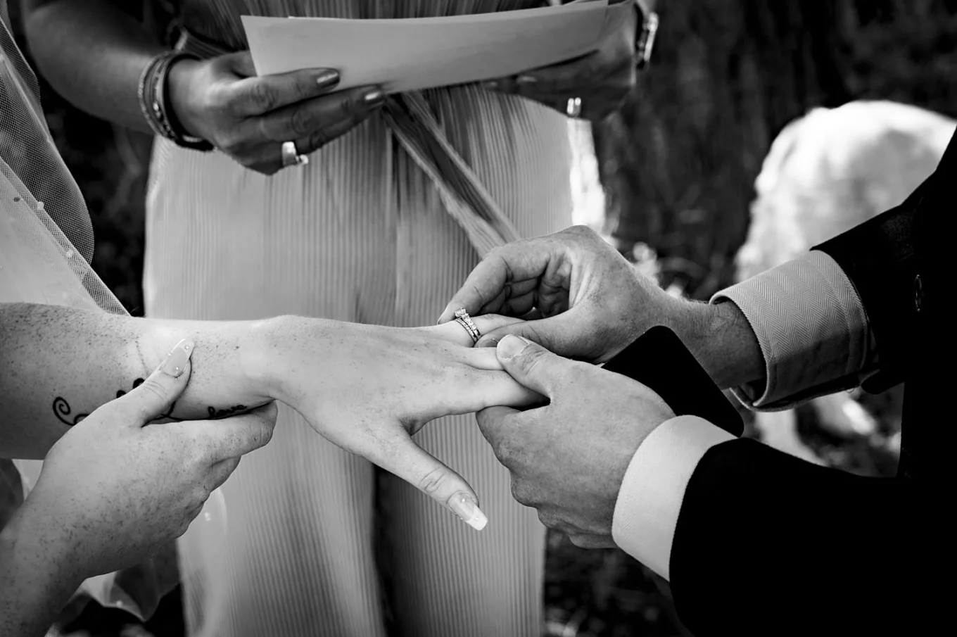 Broom puts the ring on the bride's finger.