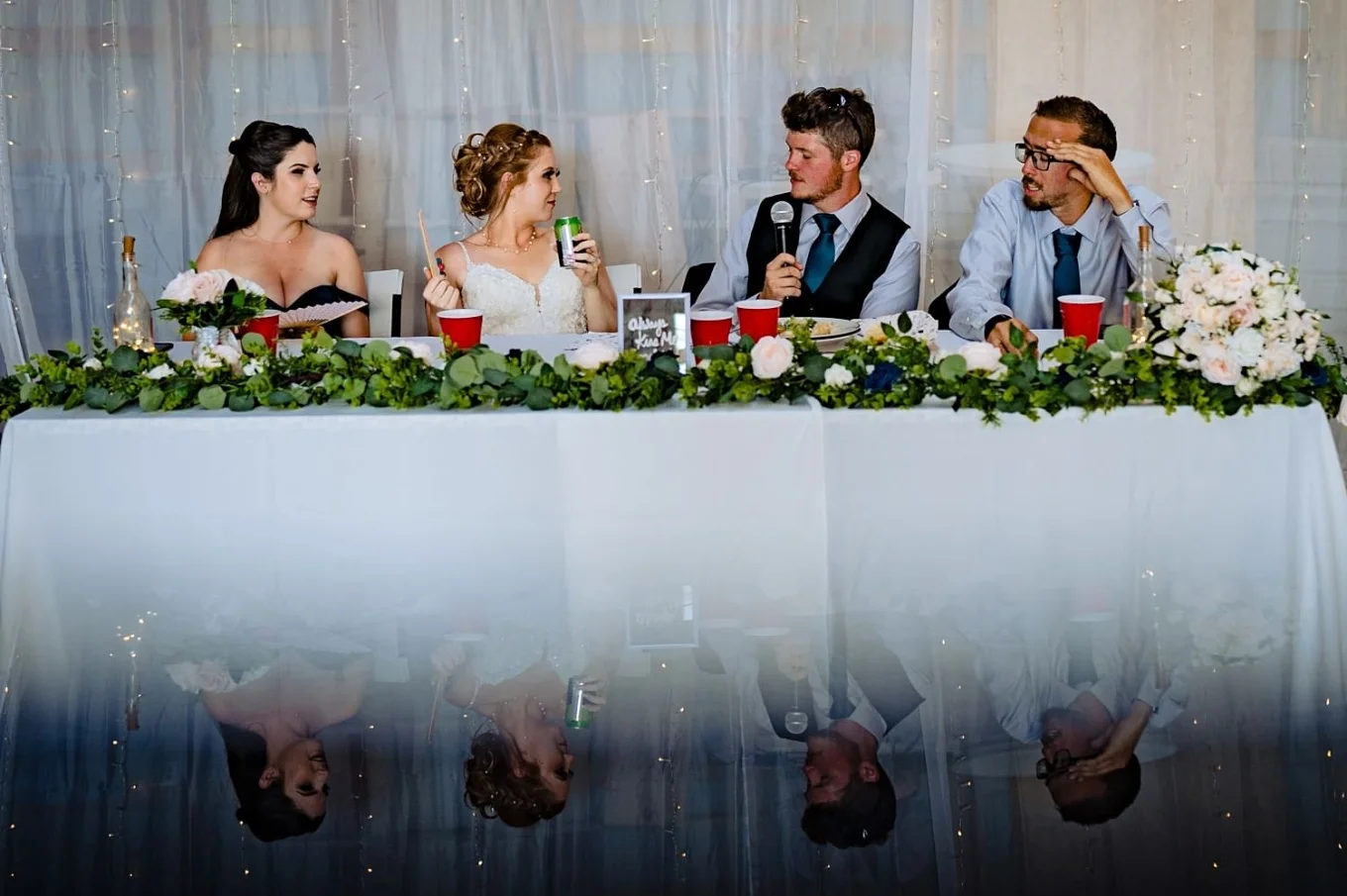 Grooms speak with unique reflection during countryside wedding in Calgary.