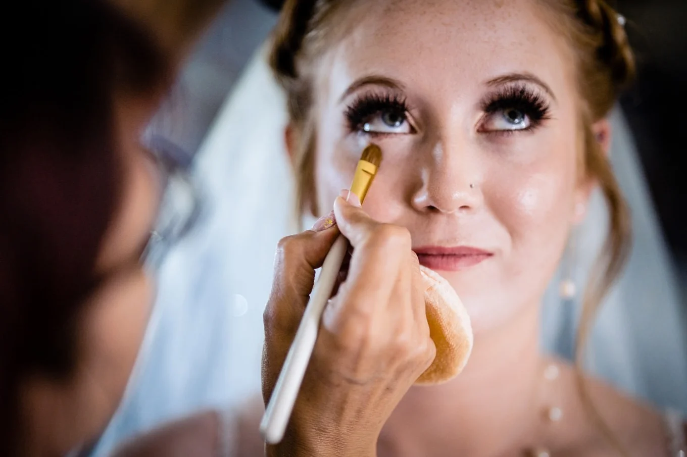 Makeup brush touches the brides face. Stunning moment from Calgary Wedding during getting ready time.