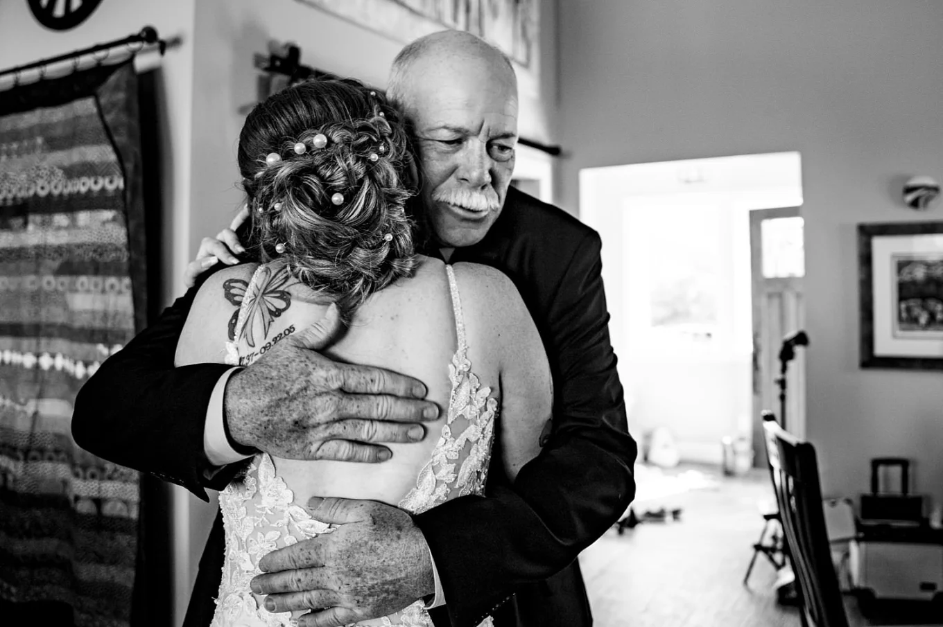 Bride's father hugs the bride before the wedding ceremony in Calgary.
