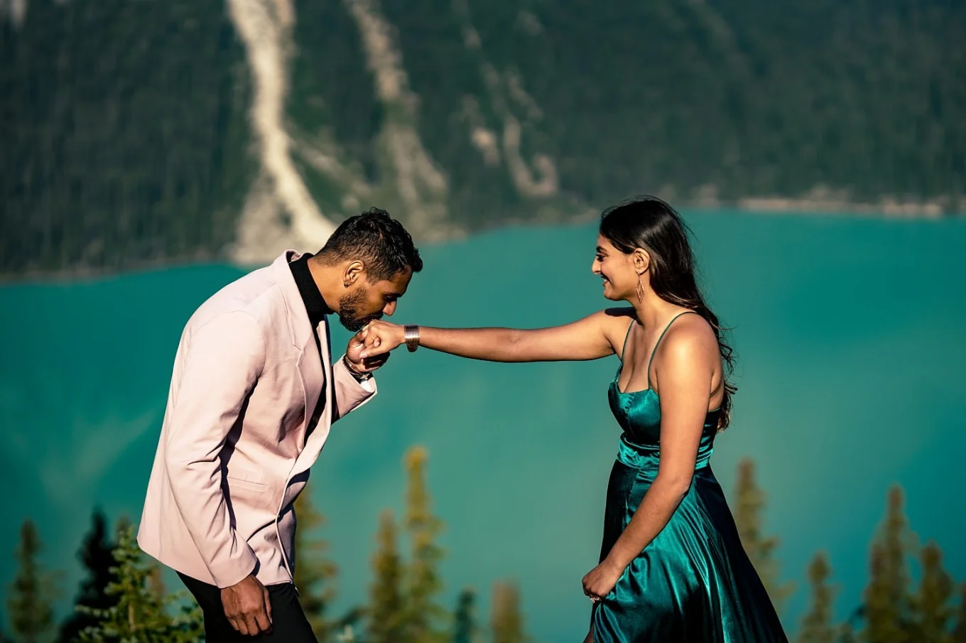 Gentleman kisses his fiancees hand.