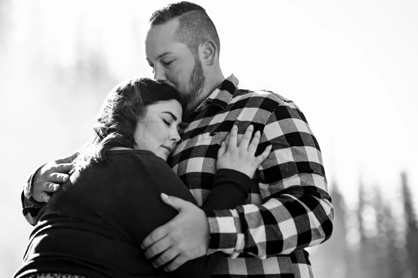 Black and white photograph of couple in a hug.