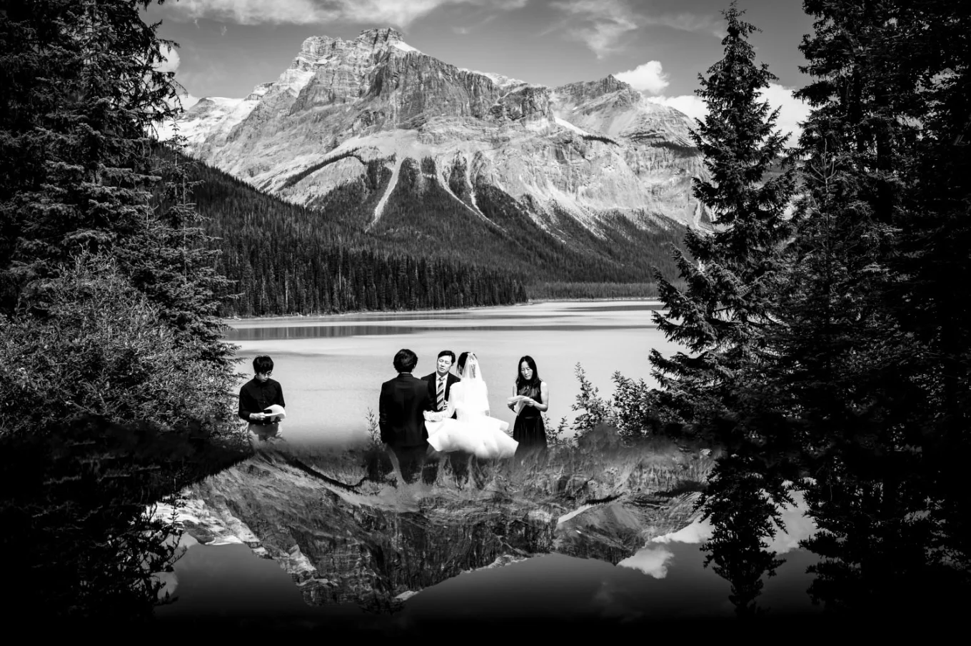 Creative wedding ceremony in the mountains with reflective effect created by the best Banff Wedding Photographers - 4Eyes Photography