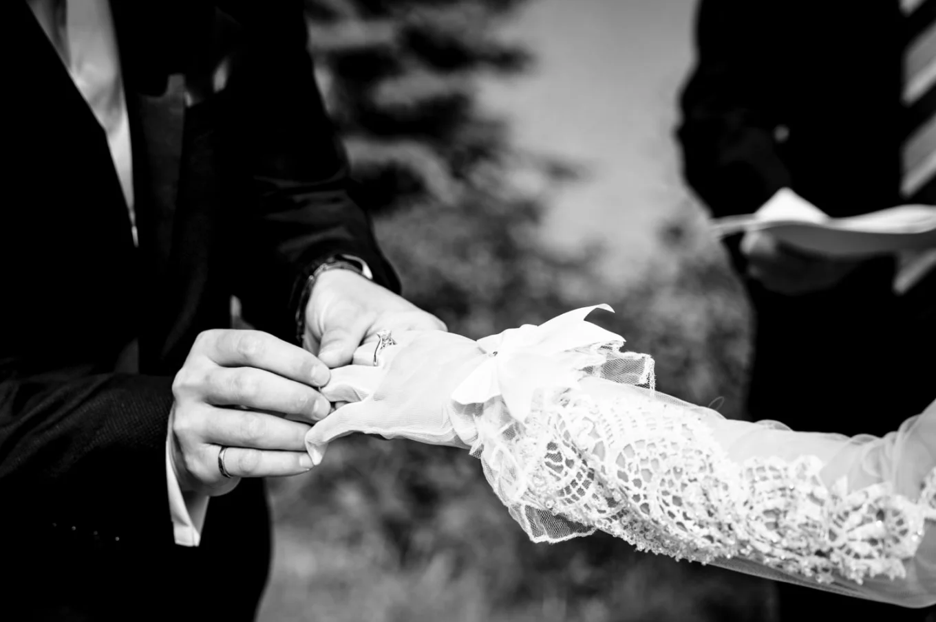 Groom puts a wedding ring on the bride;s finger