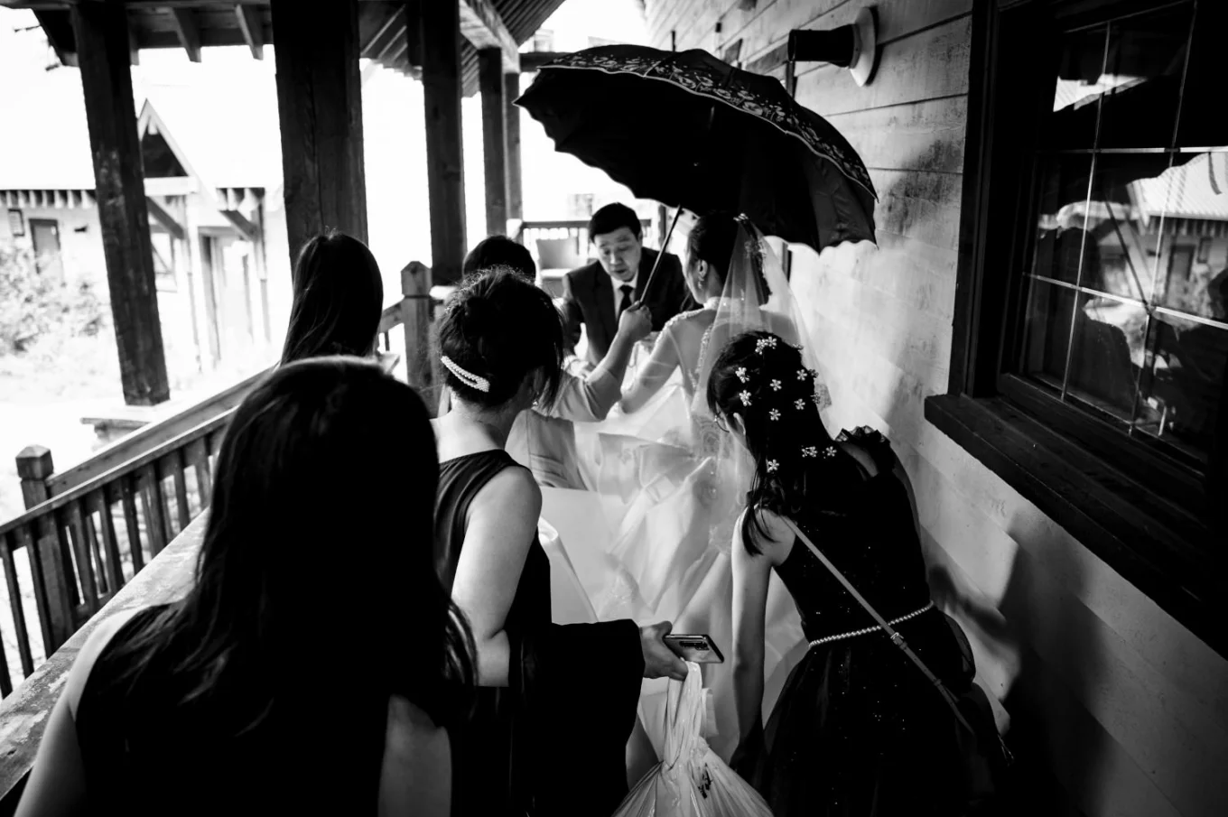 Asian family rushing for a wedding ceremony. Photograph in black and white.