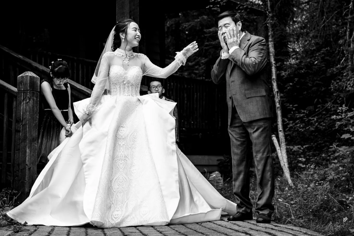 Bride's father cries before wedding while the bride tries to cheer him up.