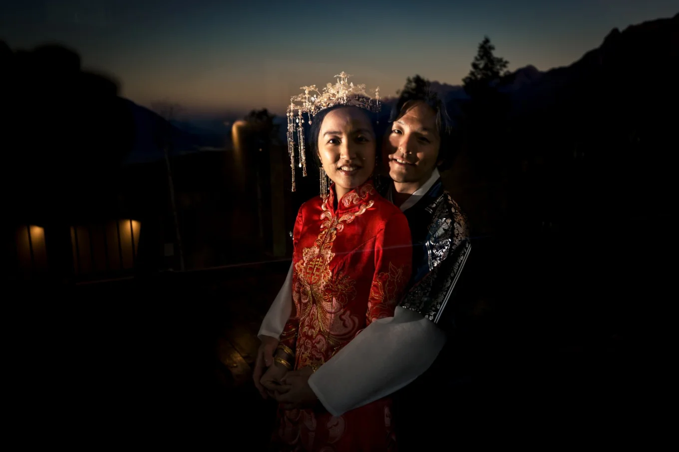 Bride and groom by the window in a hug in Banff hotel.