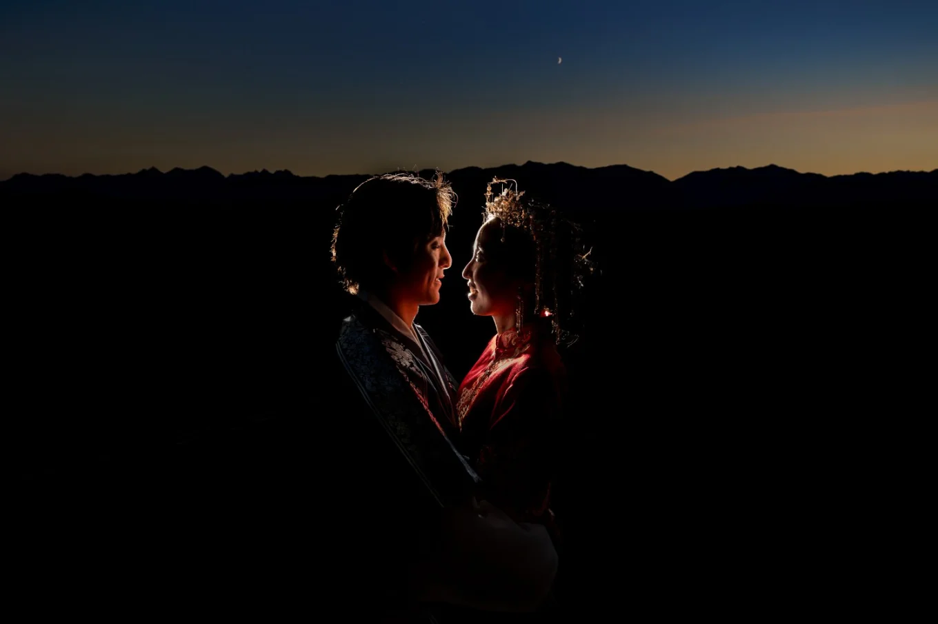Back-lighted newlyweds looking at each other during the sunset in Banff.