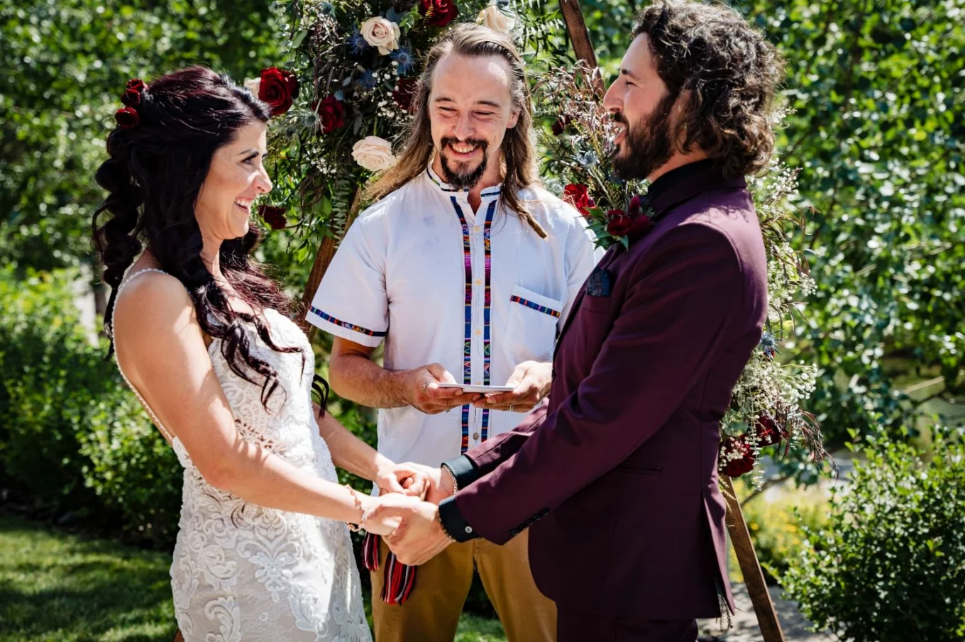 Bride and groom facing each other in front of commissioner.