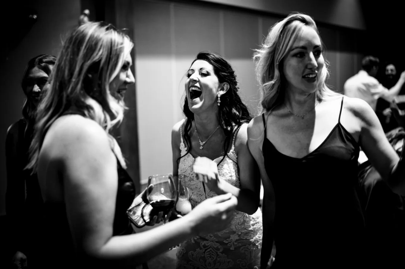 Bride laughs with her best friends.