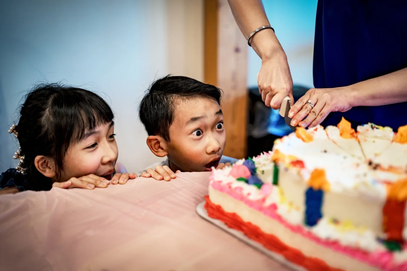 Excited kids at the wedding during cutting the cake.