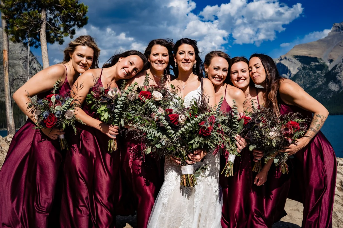 bridesmaids cuddle with the bride.