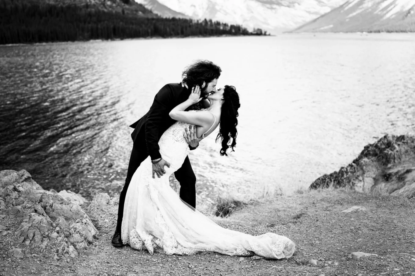 Broom dips his wife an kiss her at Minnewanka Lake.