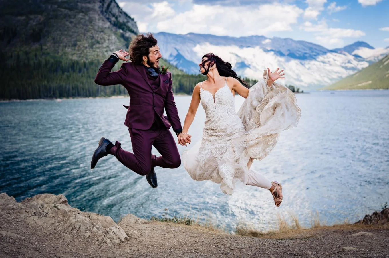 Funny jump of bride an groom by the lake.