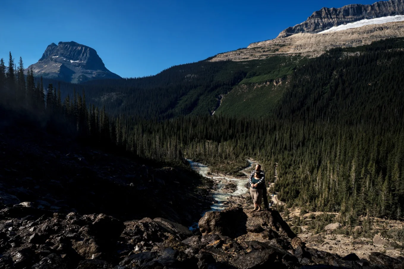 Engaged couple standing in the sun during engagement photo session with the best Banff Wedding Photographer.