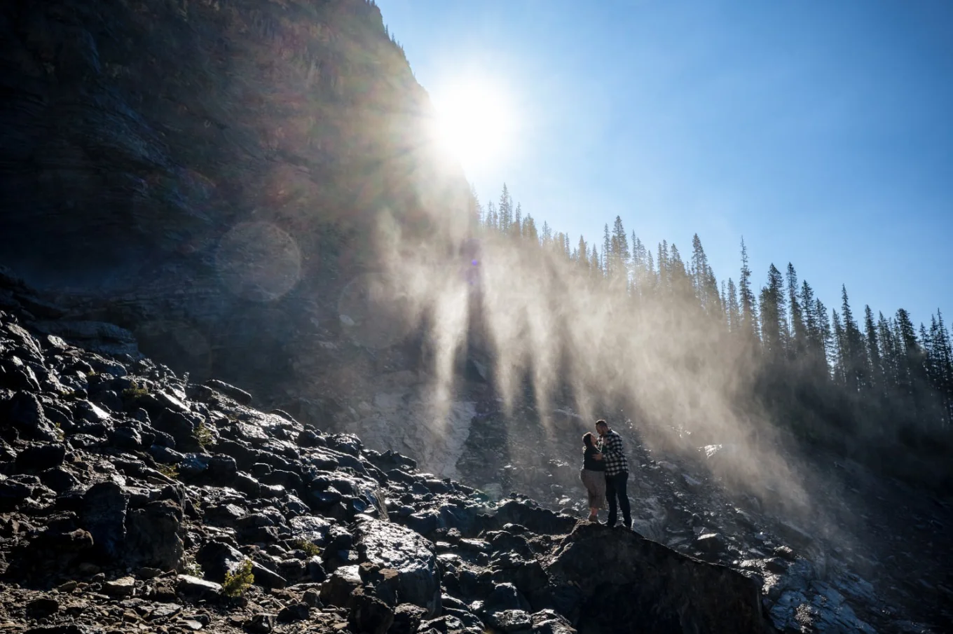 Couple in a huh at sunning waterfall in Banff.