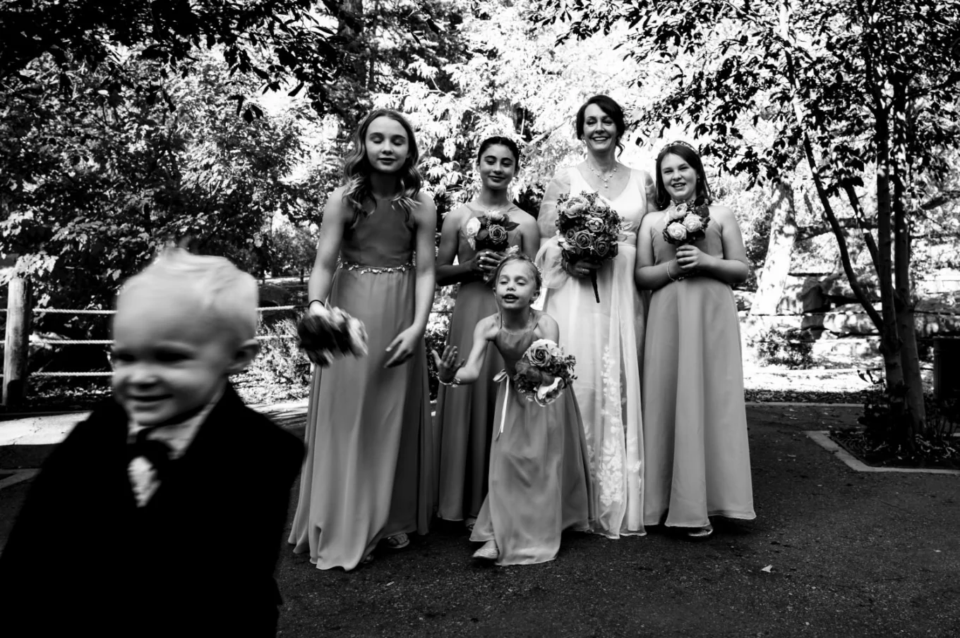 A little boy runs away fro the group photo at the Calgary wedding.