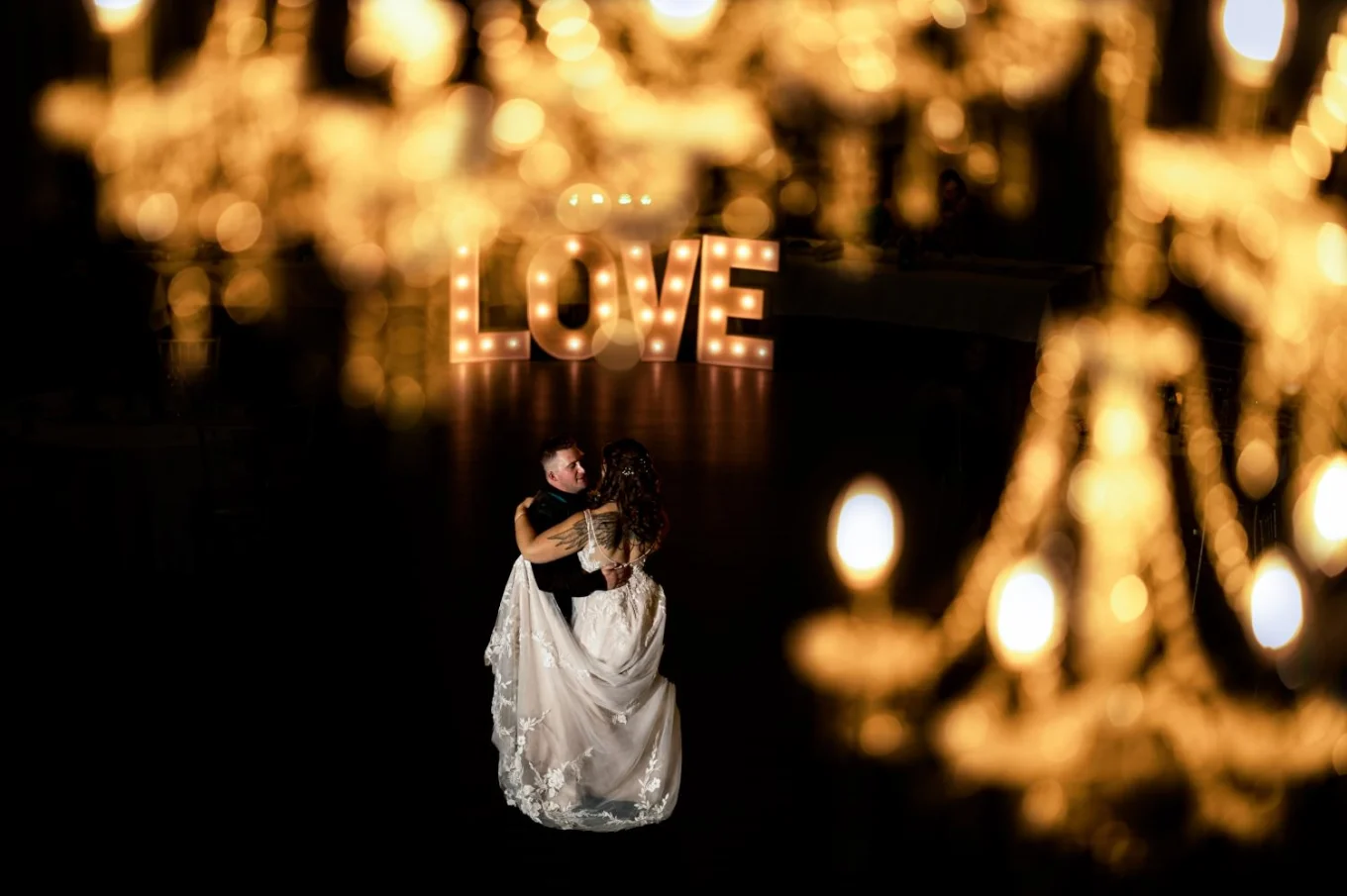 Creative Banff Wedding Photograph through chandelier. Newlyweds first dance.