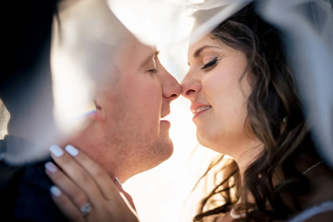 Bride and groom's intimidate moment under the veil. Unique Calgary Wedding Photography.