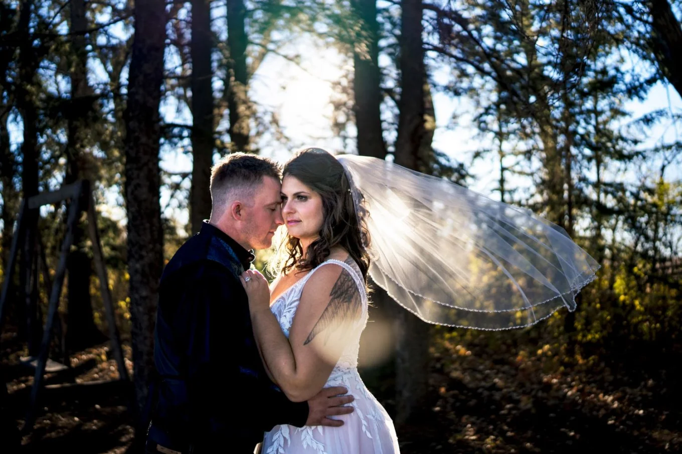 Calgary After-Wedding portrait of bride and groom hugging each other.