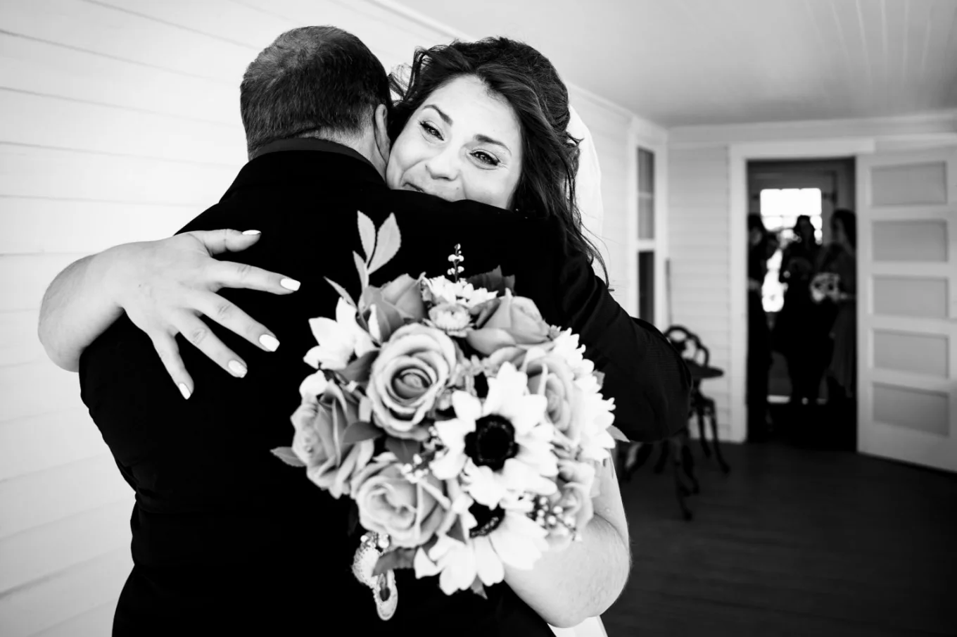 Emotional moment of bride and her father during first look before Calgary Wedding. Dad and the bride hug each other.