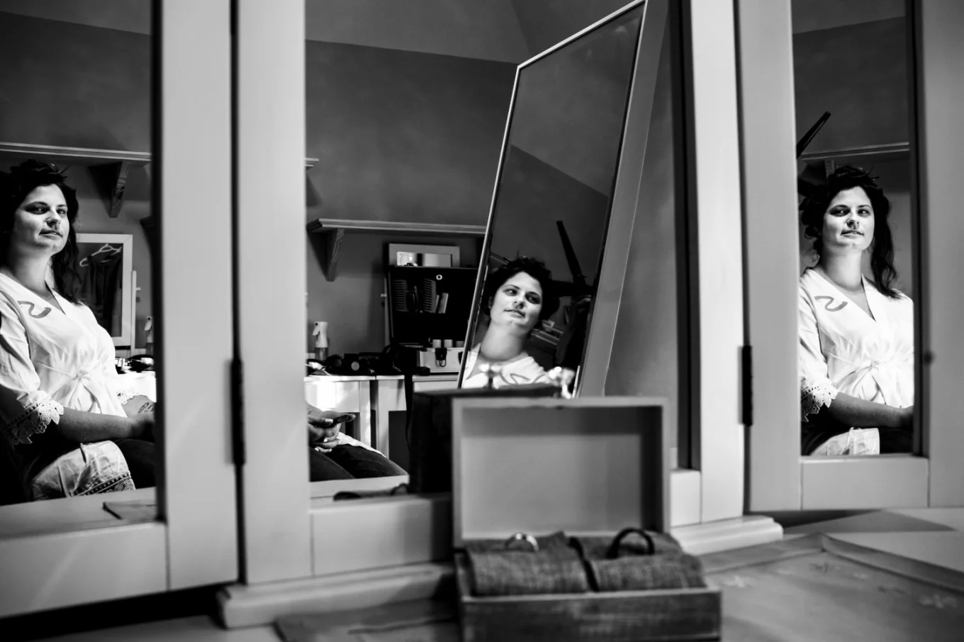 Unique photo of the bride's reflection in the mirrors taken by best Calgary Wedding Photographer.