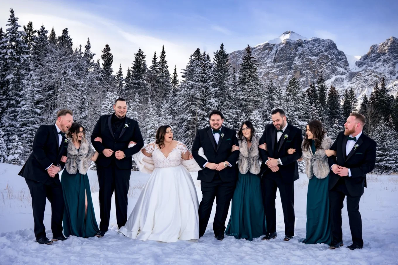 Funny and happy photography of the bridal party in Banff during wintertime.