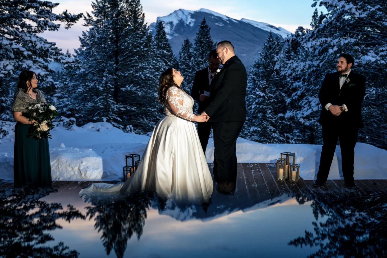 Creative photo with reflection of the sky and the mountains taken during Winter Banff Wedding Ceremony.