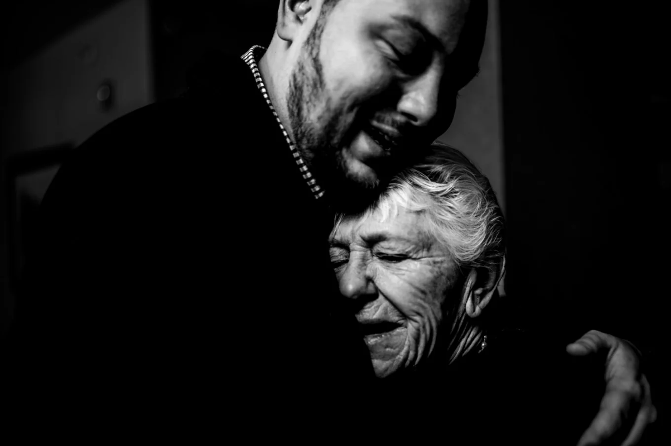 Emotional moment of the groom an his grandmother before the Banff Wedding. They are in a hug.
