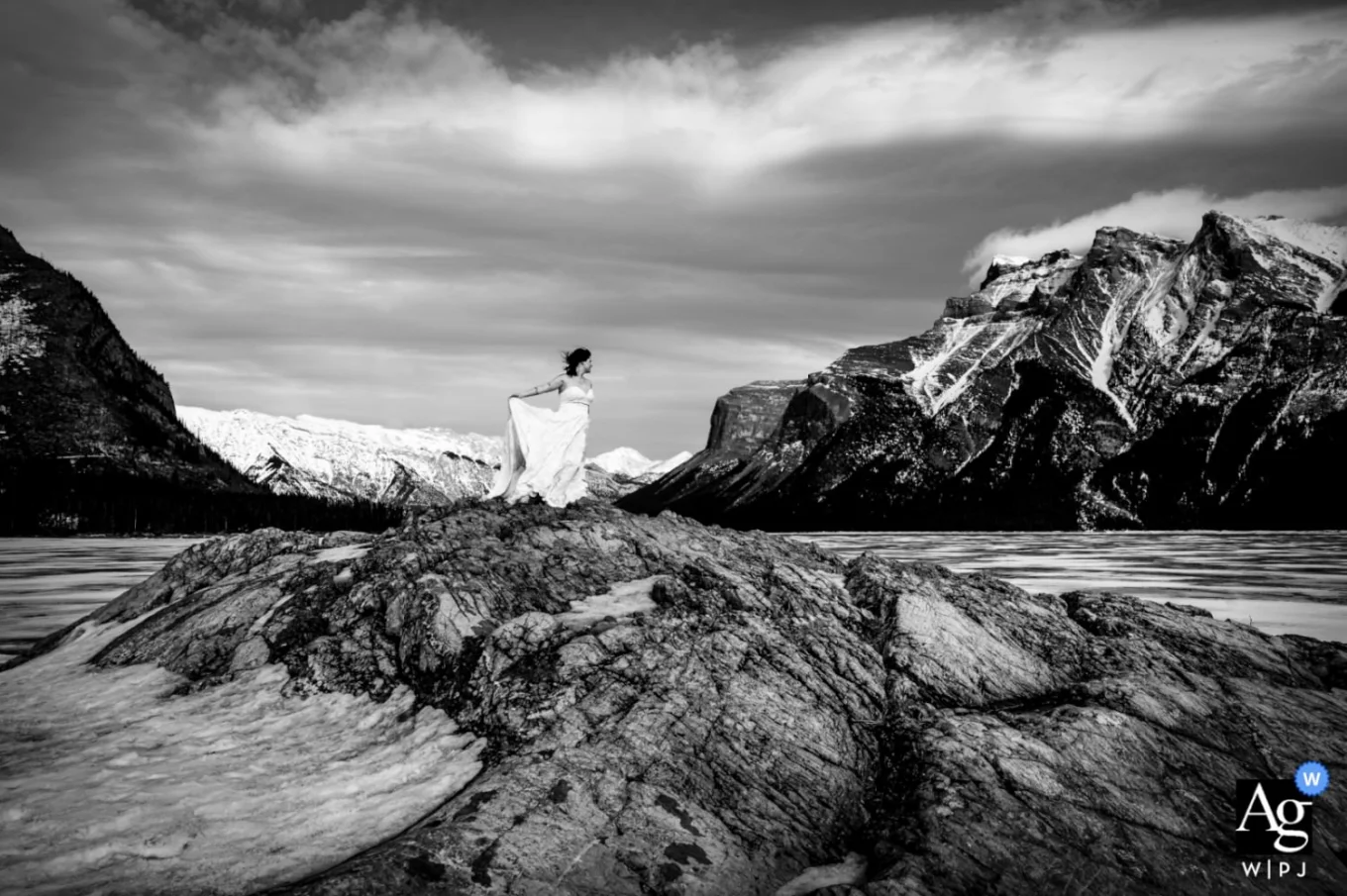 Wedding Photography in Banff of a bride at Minnewanka Lake in black and white.