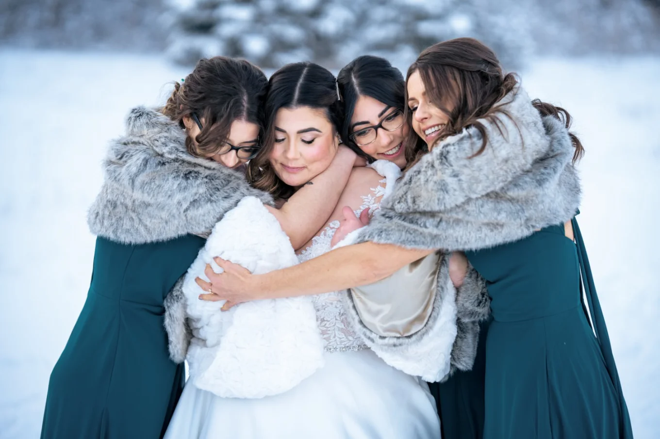 Bridesmaids give a hug to the bride.