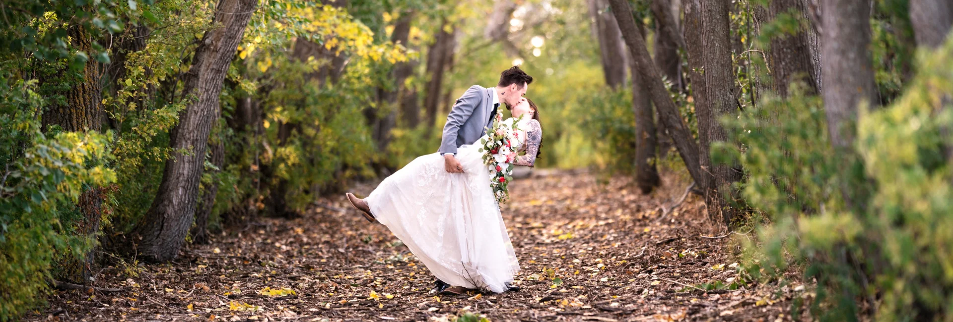 Cagary Wedding Photographer captured a newlyweds sharing a kiss in the forest
