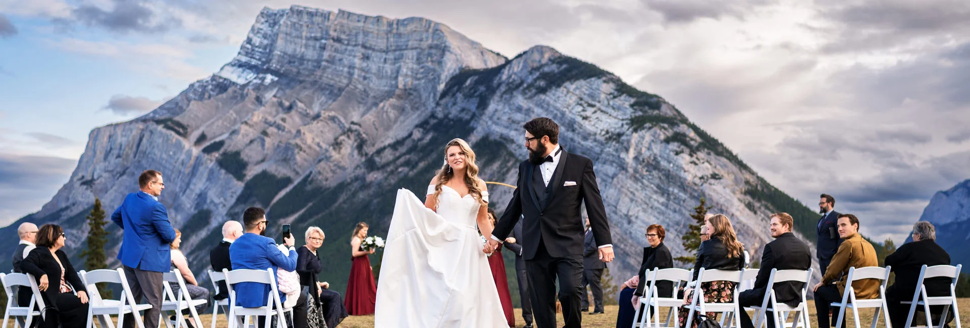 Bride and groom walkin down the aisle in Banff